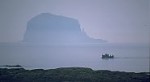 Bass Rock, calm sea, and fishing-boat, Scotland