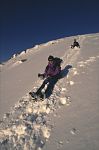 Mountaineers 'bum-sliding' down snow slope, Glen Clova, Scotland