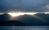 Storm cloud and sunrays over mountains and croft, Ireland