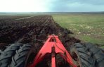 Tractor ploughing wild moorland flows for afforestation