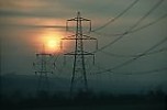 Electricity pylons with setting sun